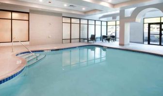 beautiful indoor pool with comfortable seating area at Embassy Suites by Hilton Seattle North Lynnwood.