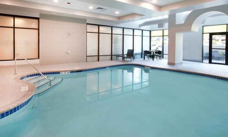 beautiful indoor pool with comfortable seating area at Embassy Suites by Hilton Seattle North Lynnwood.