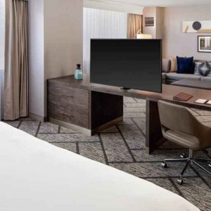 King suite with working station, TV screen and sofa at the DoubleTree by Hilton Tulsa-Downtown.