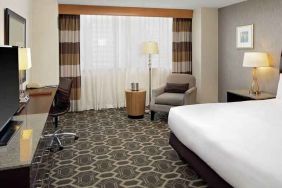 Comfortable and bright king bedroom at the DoubleTree by Hilton Tulsa-Downtown.