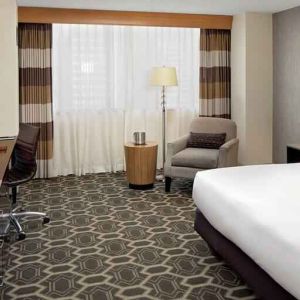 Comfortable and bright king bedroom at the DoubleTree by Hilton Tulsa-Downtown.