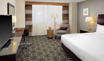 Comfortable and bright king bedroom at the DoubleTree by Hilton Tulsa-Downtown.