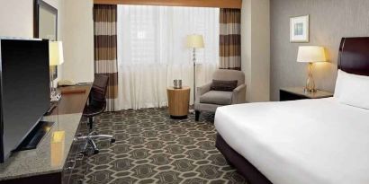 Comfortable and bright king bedroom at the DoubleTree by Hilton Tulsa-Downtown.