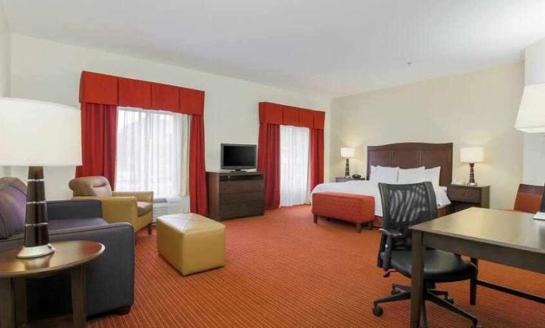 Working station with desk and sofa in a king guestroom at the Hampton Inn Champaign Urbana.