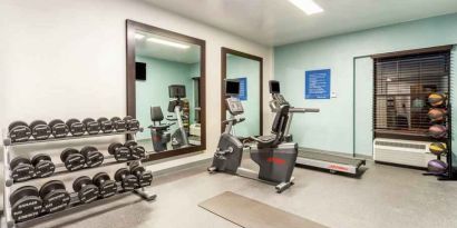 Fitness center with weights and mirrors at the Hampton Inn Boston-Peabody.