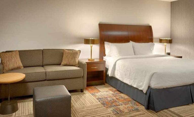 comfortable king room with lounge area at Hilton Garden Inn Salt Lake City/Sandy.