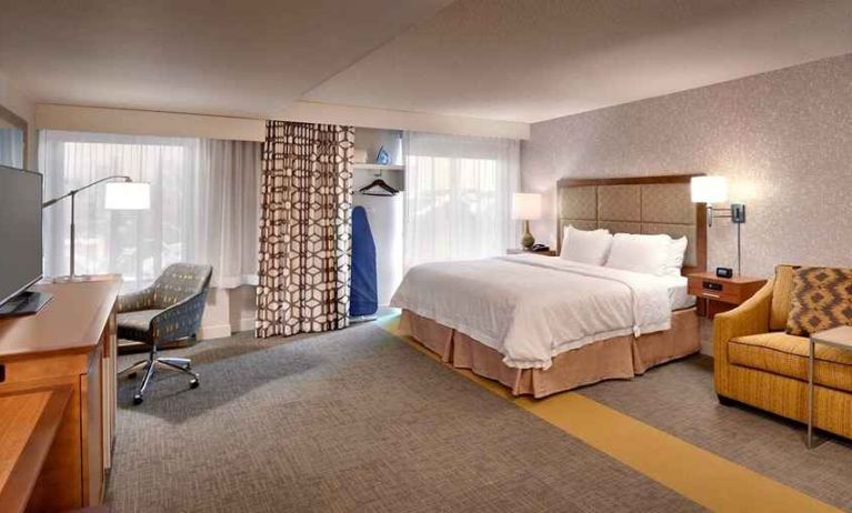 spacious king suite with lounge, work area, TV and natural light at Hampton Inn Salt Lake City-Downtown.