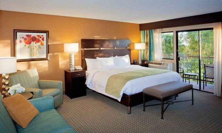 spacious king suite with balcony seating and lounge area at DoubleTree by Hilton Hotel Santa Fe.