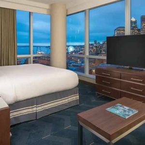 beautiful king suite with TV and city views at Embassy Suites by Hilton Seattle Downtown Pioneer Square.