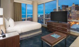 beautiful king suite with TV and city views at Embassy Suites by Hilton Seattle Downtown Pioneer Square.