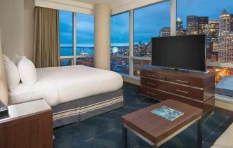 beautiful king suite with TV and city views at Embassy Suites by Hilton Seattle Downtown Pioneer Square.