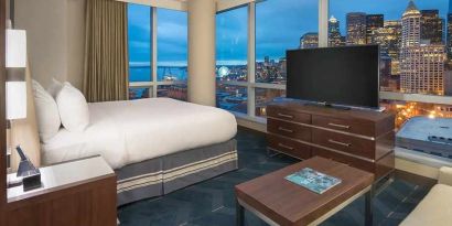 beautiful king suite with TV and city views at Embassy Suites by Hilton Seattle Downtown Pioneer Square.