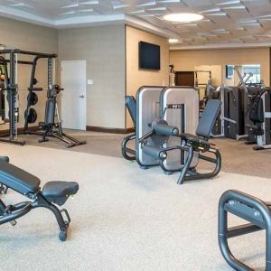 fully equipped fitness center with weights and exercise equipment at Embassy Suites by Hilton Seattle Downtown Pioneer Square.