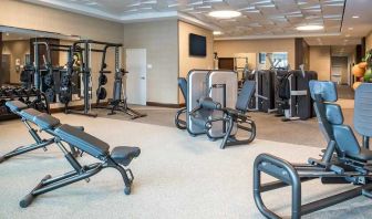 fully equipped fitness center with weights and exercise equipment at Embassy Suites by Hilton Seattle Downtown Pioneer Square.