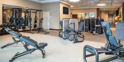 fully equipped fitness center with weights and exercise equipment at Embassy Suites by Hilton Seattle Downtown Pioneer Square.