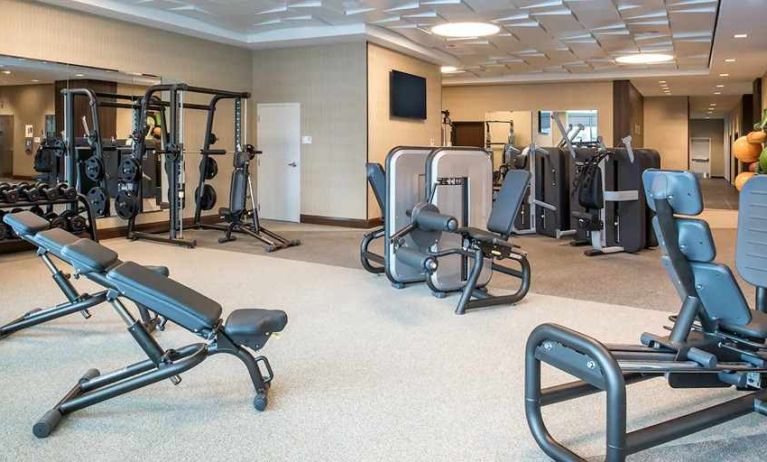 fully equipped fitness center with weights and exercise equipment at Embassy Suites by Hilton Seattle Downtown Pioneer Square.