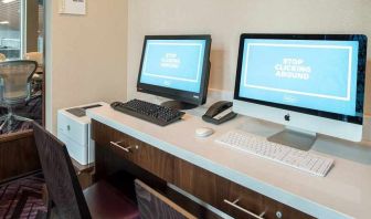 dedicated business center with printers, internet, and work desks ideal for working remotely at Embassy Suites by Hilton Seattle Downtown Pioneer Square.