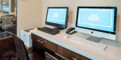 dedicated business center with printers, internet, and work desks ideal for working remotely at Embassy Suites by Hilton Seattle Downtown Pioneer Square.