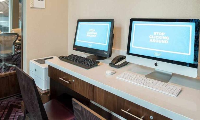 dedicated business center with printers, internet, and work desks ideal for working remotely at Embassy Suites by Hilton Seattle Downtown Pioneer Square.