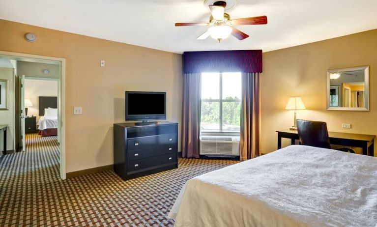 KIng bedroom with window and desk at the Homewood Suites by Hilton Bel Air.