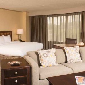 Spacious and comfortable king suite with sofa at the DoubleTree by Hilton Tulsa - Warren Place.