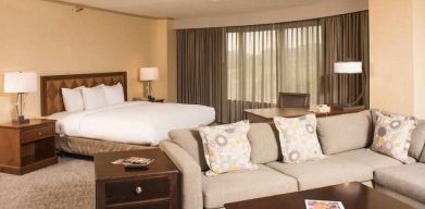 Spacious and comfortable king suite with sofa at the DoubleTree by Hilton Tulsa - Warren Place.