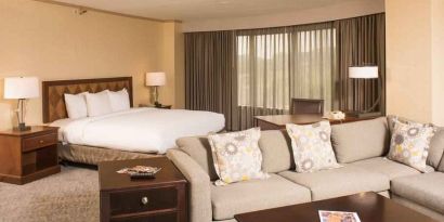 Spacious and comfortable king suite with sofa at the DoubleTree by Hilton Tulsa - Warren Place.