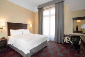 Bright king bedroom with desk and window at the Hampton Inn & Suites Mexico City - Centro Historico.