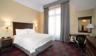 Bright king bedroom with desk and window at the Hampton Inn & Suites Mexico City - Centro Historico.