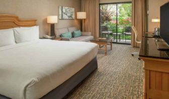 Bright king bedroom with large window overlooking the patio at the DoubleTree by Hilton Sonoma Wine Country.