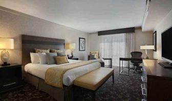 Presidential suite with king size bed and desk at the Embassy Suites by Hilton Napa Valley.