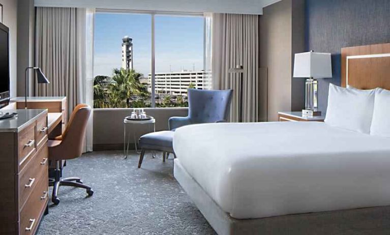 Bright king bedroom with window at the Hilton New Orleans Airport.