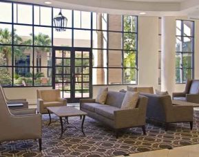 Comfortable lobby workspace with sofas at the Hilton New Orleans Airport.