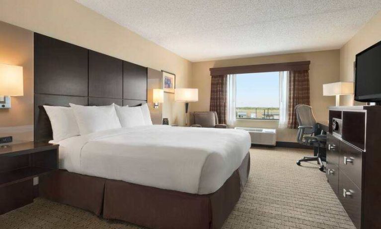 Bright king bedroom with window at the DoubleTree by Hilton Wichita Airport.