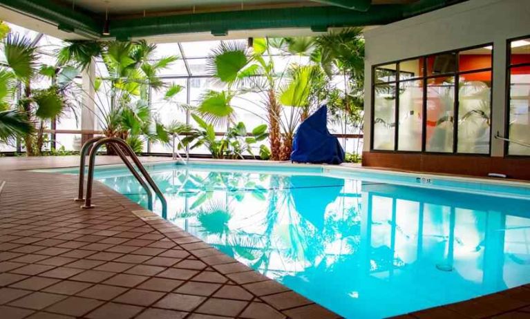 Beautiful indoor pool with plants at the DoubleTree by Hilton Wichita Airport.