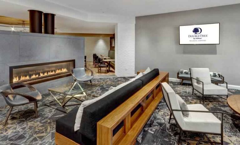 Stylish lobby workspace by the fireplace at the DoubleTree by Hilton Wichita Airport.