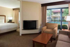 Hotel suite with king size bed, sofa and pool view at the DoubleTree Suites by Hilton Cincinnati-Blue Ash.