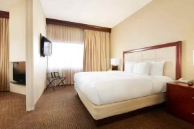 King bedroom with window at the DoubleTree Suites by Hilton Cincinnati-Blue Ash.