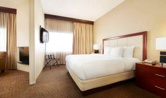 King bedroom with window at the DoubleTree Suites by Hilton Cincinnati-Blue Ash.