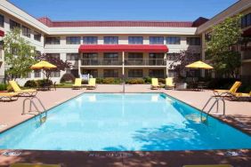 Outdoor pool area with lounges at the DoubleTree Suites by Hilton Cincinnati-Blue Ash.