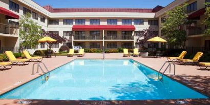 Outdoor pool area with lounges at the DoubleTree Suites by Hilton Cincinnati-Blue Ash.