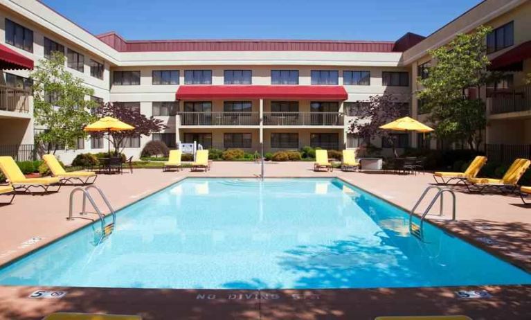 Outdoor pool area with lounges at the DoubleTree Suites by Hilton Cincinnati-Blue Ash.