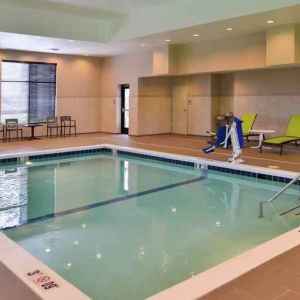 Indoor pool area with lounges and chairs at the Hampton Inn & Suites St. Paul Oakdale/Woodbury by Hilton.