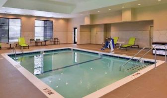 Indoor pool area with lounges and chairs at the Hampton Inn & Suites St. Paul Oakdale/Woodbury by Hilton.