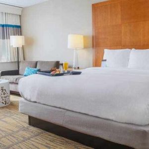 King bedroom with sofa and window at the DoubleTree by Hilton Rochester.