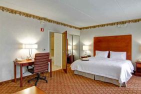 King bedroom with desk at the Hampton Inn & Suites Leesburg.