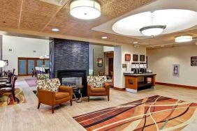 Comfortable lobby workspace by the fireplace at the Hampton Inn & Suites Leesburg.