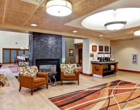 Comfortable lobby workspace by the fireplace at the Hampton Inn & Suites Leesburg.