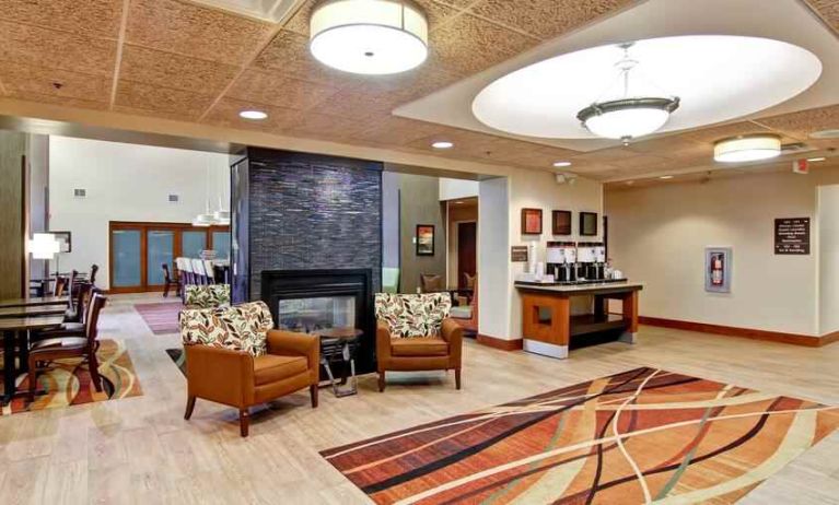 Comfortable lobby workspace by the fireplace at the Hampton Inn & Suites Leesburg.