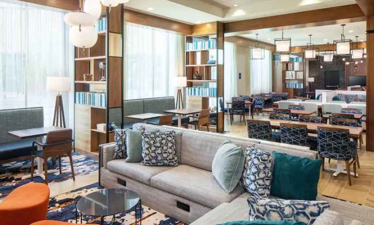 Seating area with sofas, tables and chairs at the Hampton Inn Boston Seaport District.